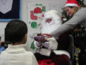 Santa gives gifts and listens to the childrens wishes